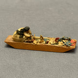 Miniature Native American woman paddling dugout canoe with fabric flowers  (SSC37)