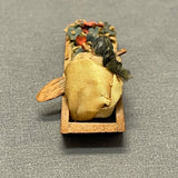 Miniature Native American woman paddling dugout canoe with fabric flowers  (SSC37)
