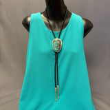 Turquoise bolo tie with hinge revealing a hand-cut Navajo scene (JF116)